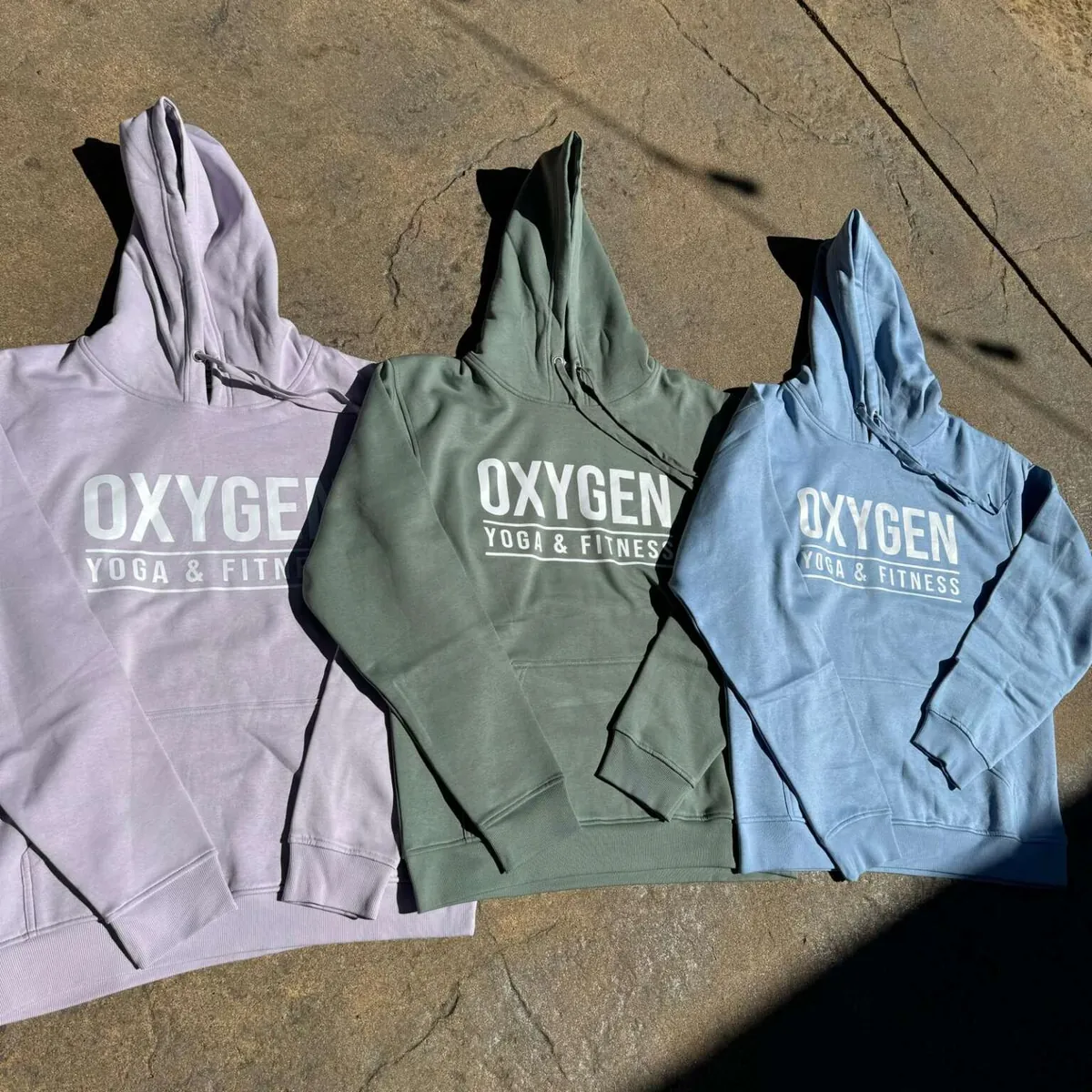 Custom branded hoodies produced for Oxygen Yoga & Fitness in Vancouver by Fresh Prints Supply Co.