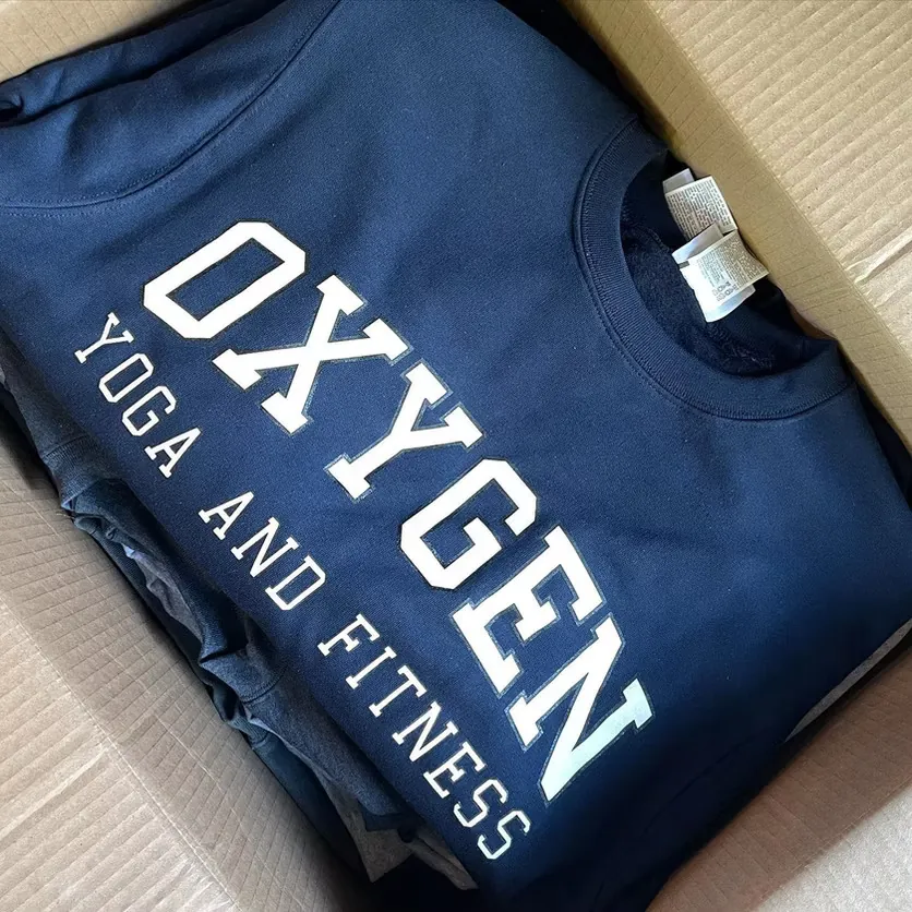 Navy crewneck sweatshirt in a box, printed with OXYGEN YOGA AND FITNESS in white