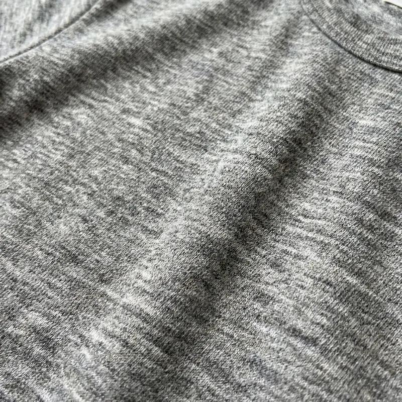 Close-up of heathered grey tri-blend fabric
